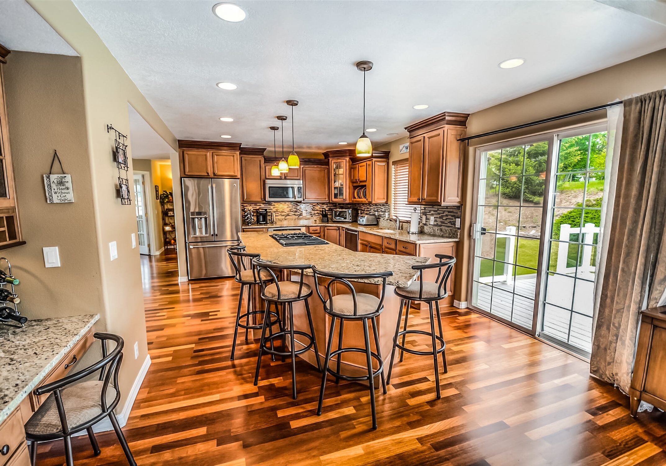 Beautifully finished hardwood floors in the kitchen. Dark wood adds value to any home.